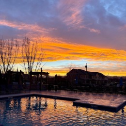 beautiful pool view with colorful sunset
