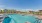 Large sparkling blue pool with a large pool deck 